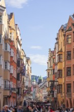 Many people and historic houses in Herzog-Friedrich-Straße, Altstadt, Innsbruck, Tyrol, Austria