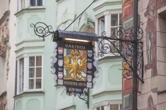 Old hanging sign from Gasthof Goldener Adler in Herzog-Friedrich-Straße, Old Town, Innsbruck,