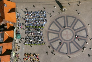 Hanseatic cross in front of the Bremen Roland on the market square of Bremen in front of the town