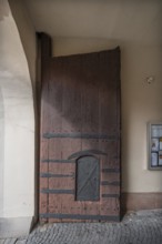 Left side of the wooden gate with manhole at the entrance to the fortified church, around 1500,