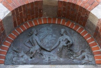 Lighthouse, access to the Kiel Canal, NOK, relief above the front door, symbol, mermaids of the