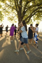 People dancing in the sun, Promenade, Bregenz, Lake Constance, Vorarlberg, Austria