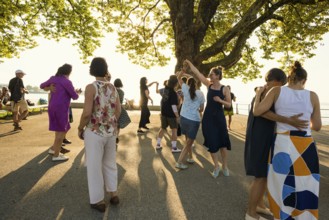 People dancing in the sun, Promenade, Bregenz, Lake Constance, Vorarlberg, Austria