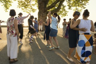 People dancing in the sun, Promenade, Bregenz, Lake Constance, Vorarlberg, Austria