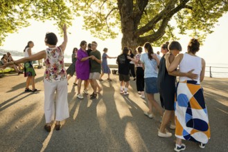 People dancing in the sun, Promenade, Bregenz, Lake Constance, Vorarlberg, Austria