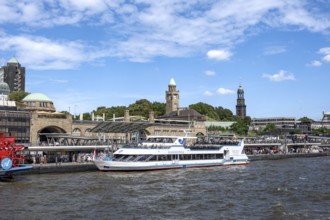 Elbe and boats at St. Pauli Landungsbrücken, historic building with water level tower, Hamburg,