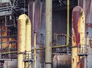 Weathered rusty industrial scenery with old corroded steel girders and metal tubes