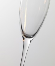 Studio photography of a champagne glass detail with warm light reflections