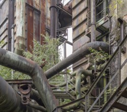 Weathered rundown industrial scenery with old corroded steel girders and metal tubes