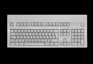 Studio photography of a grey keypad in black back, seen from above