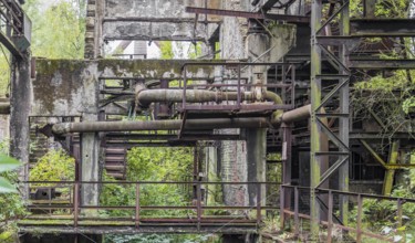 Weathered rundown industrial scenery with old corroded steel girders and metal tubes