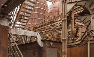 Weathered rusty industrial scenery with old corroded steel girders and metal tubes