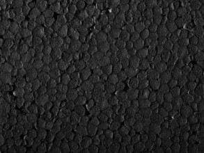 Full frame closeup of a black Polystyrene surface