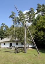 Idyllic rural scenery including a historic standpost in Romania