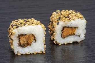 Two sushi dish on dark grey stone surface