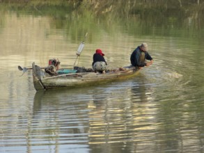 Riparian scenery with small boat at a river in Cambodia