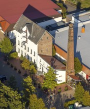 Aerial photograph, WEZ supermarket, stork's nest on the chimney of the Alte Kornbrennerei, Hille,