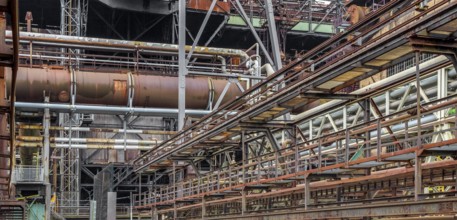 Weathered rundown industrial scenery with old corroded steel girders and metal tubes