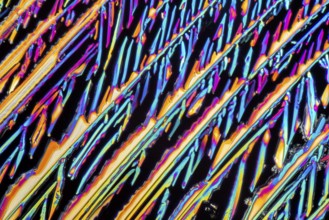 Colorful microscopic shot of Sodium nitrate microcrystals in polarized light