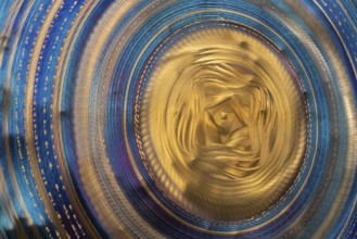 Full frame abstract closeup shot of a colorful metallic asian gong