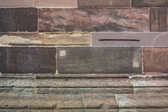 Historic engravings on a stone wall at the Freiburg Minster in Freiburg im Breisgau, a city in