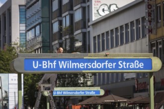 DEU Germany Germany A painter paints a sign for the underground railway in Wilmersdorfer Strasse