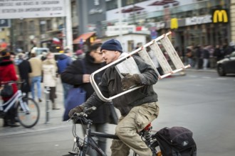 DEU Germany Germany Berlin Cyclist with trained ladder passes Checkpoint Charlie