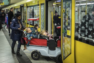 DEU Germany Germany Berlin Carer with pram for several kindergarten children in the underground