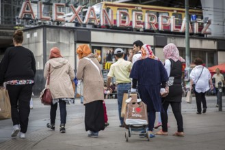 DEU Germany Germany Berlin Muslim family with a hackney carriage on Alexanderplatz. 'I love