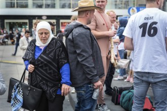 DEU Germany Germany Berlin A Muslim woman passes a young man on Alexanderplatz
