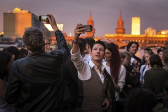 DEU Germany Germany Berlin Sunset on the terrace of the Fluxbau with the Oberbaum Bridge in the