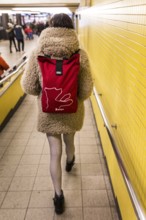 DEU Germany Germany Berlin A woman wears a Berlinale backpack with a plush coat and fishnet