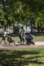 DEU Germany Germany Berlin Jogging mothers with prams in Monbijoupark in Mitte