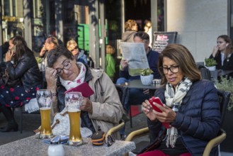 DEU Germany Germany Berlin Guests smoke, talk on the phone, read their mobile phones or look at the
