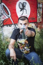 Germany Germany DEU Berlin Graffiti artist Ibo Omari in front of one of his works on a playground
