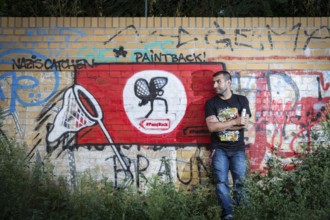 Germany Germany DEU Berlin Graffiti artist Ibo Omari in front of one of his works on a playground