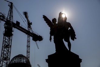 DEU Germany Germany Berlin The shell of the city palace backlit with statues on the bridge