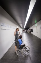 DEU Germany Germany Berlin Disabled tourist in a wheelchair explores Berlin with a city guide.