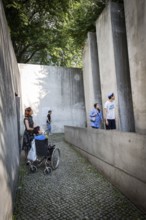 DEU Germany Germany Berlin Disabled tourist in a wheelchair explores Berlin with a city guide.