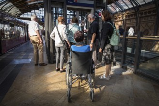DEU Germany Germany Berlin Disabled tourist in a wheelchair explores Berlin with a city guide.