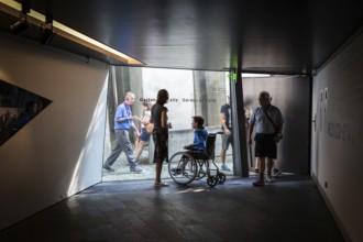 DEU Germany Germany Berlin Disabled tourist in a wheelchair explores Berlin with a city guide.