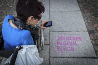 DEU Germany Germany Berlin Disabled tourist in a wheelchair explores Berlin with a city guide.