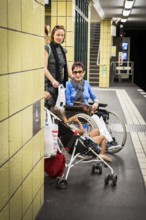 DEU Germany Germany Berlin Disabled tourist in a wheelchair explores Berlin with a city guide