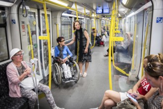 DEU Germany Germany Berlin Disabled tourist in a wheelchair explores Berlin with a city guide
