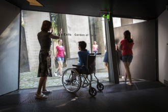 DEU Germany Germany Berlin Disabled tourist in a wheelchair explores Berlin with a city guide.