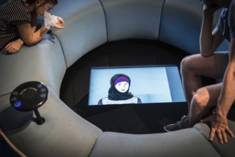 DEU Germany Germany Berlin Visitors watch an explanatory film on the subject of head coverings at