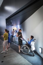 DEU Germany Germany Berlin Disabled tourist in a wheelchair explores Berlin with a city guide.