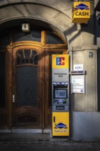 DEU Germany Germany Berlin An ATM stands in front of the entrance to an old building on