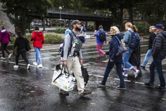 DEU Germany Germany Berlin A father with his two children on his stomach and back walks with