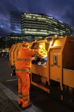 DEU Germany Germany Berlin A BSR employee unloads a rubbish bag in his vehicle on the Kudamm